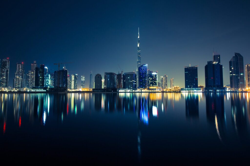 Dubai skyline at night with the Burj Khalifa lit up and reflected in the water
