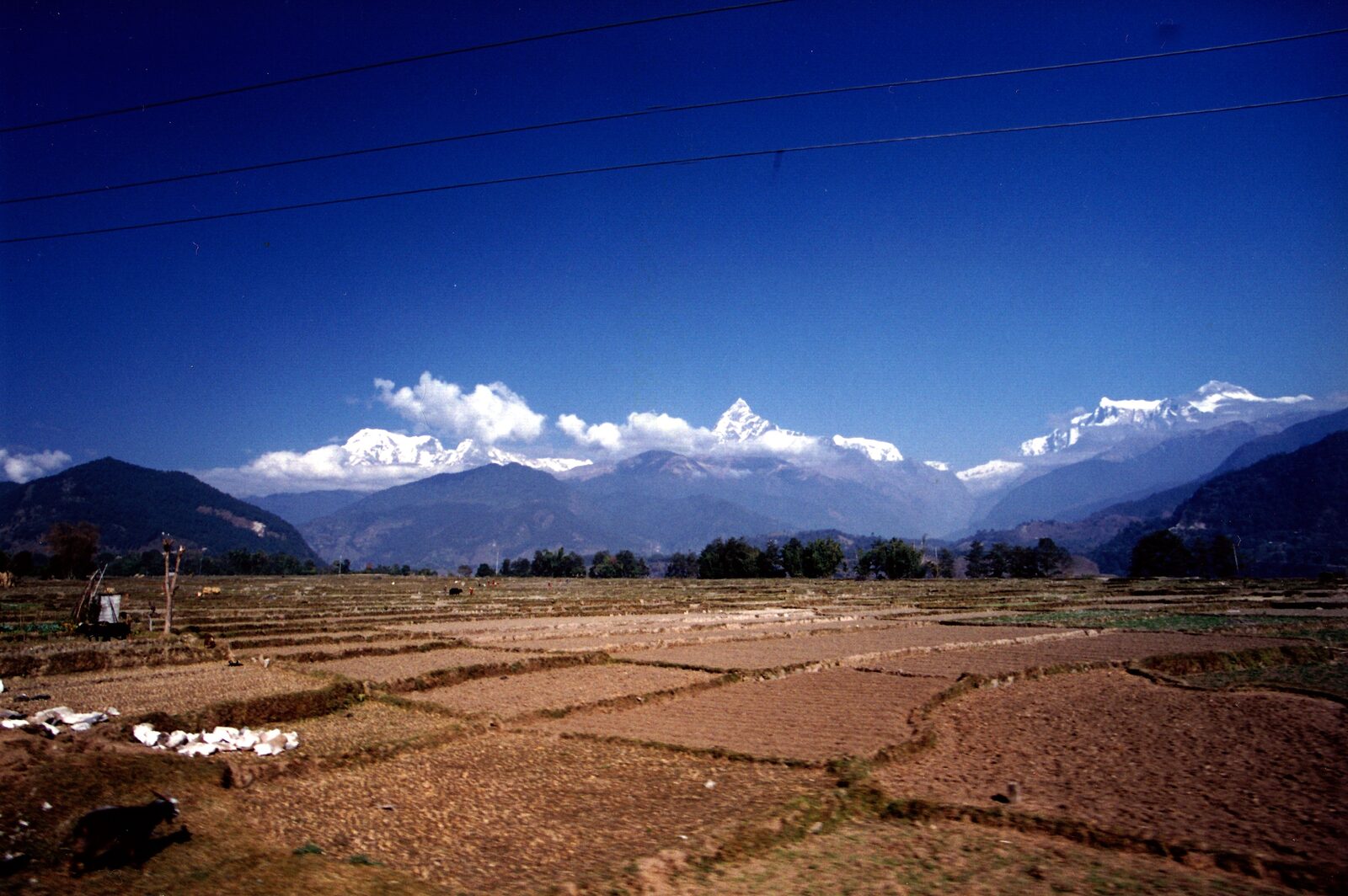 Snow-capped Annapurna and Machapuchare peaks rising above the Pokhara valley under a clear autumn sky in Nepal