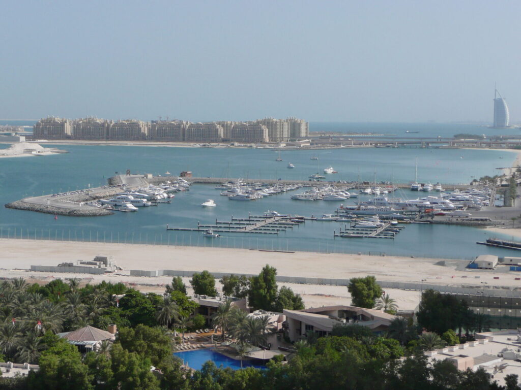 Dubai Marina skyline seen from the coast, with Palm Jumeirah and the Burj Al Arab in the distance