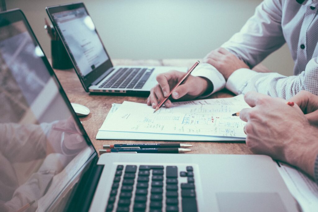 Two business partners reviewing a proposal at a desk