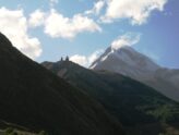 Gergeti Trinity Church on a ridge below the snow-capped peak of Mount Kazbek, Kazbegi, Georgia