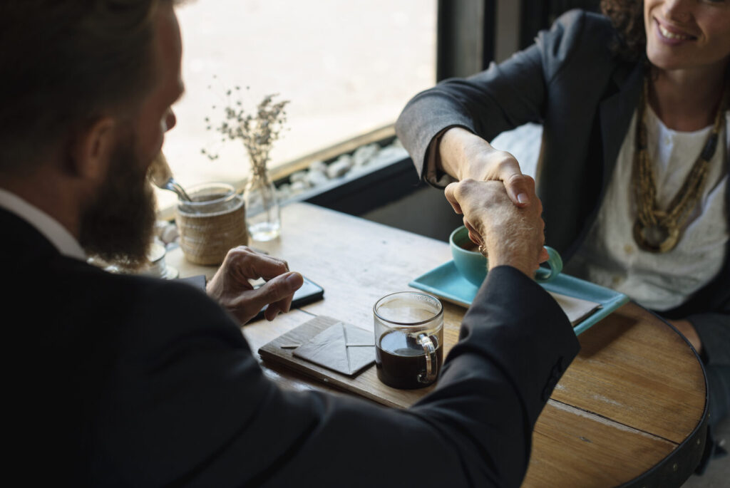 Two business partners shaking hands on an agreement