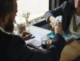 Two business partners shaking hands on an agreement