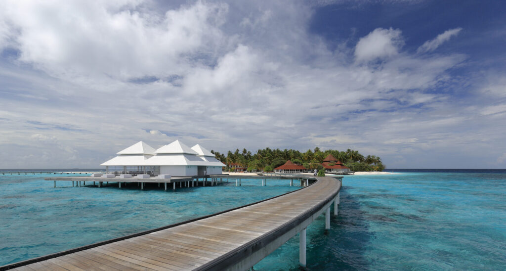 Maldives overwater villas and a jetty over a calm turquoise lagoon