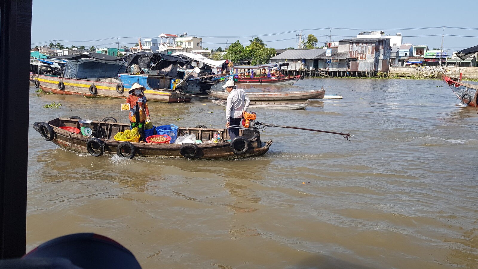 Wooden boats laden with produce at a floating market on the Mekong Delta, southern Vietnam