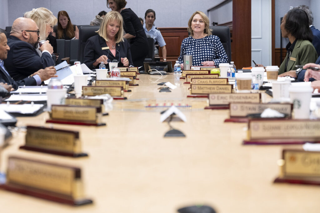 Corporate event planners meeting around a boardroom table to brief a DMC