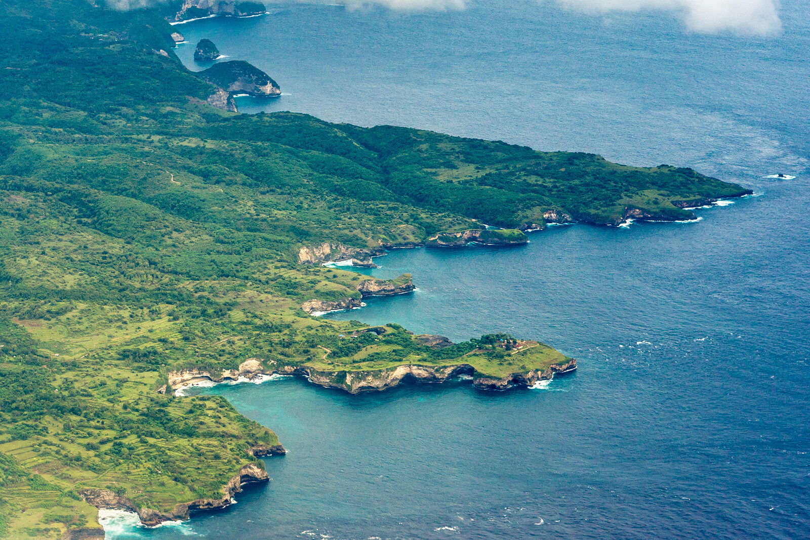 Aerial view of the rugged green coastline of Nusa Penida island near Bali