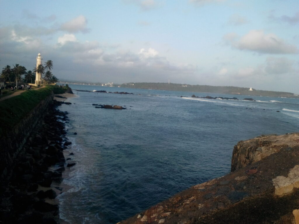 Galle Fort lighthouse above the rocky southern coastline of Sri Lanka
