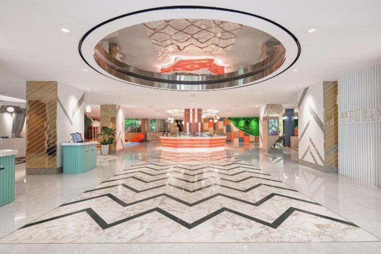 Hotel lobby with patterned marble floor at Furama RiverFront Singapore
