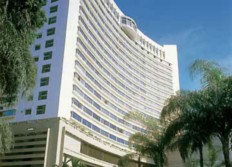 Curved facade of Furama RiverFront Singapore seen from the street