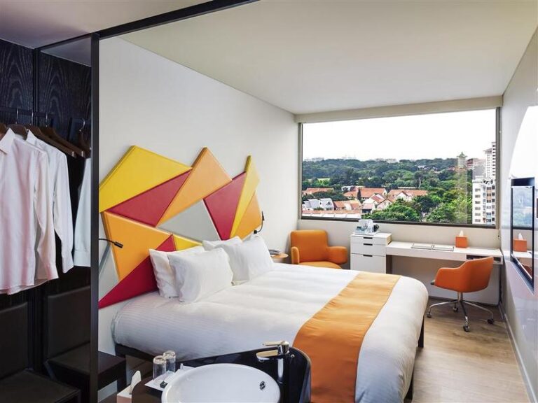 Guest bedroom with city view at ibis Styles Singapore On Macpherson