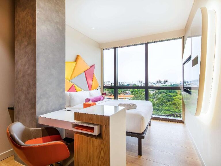 Guest room with desk and window seat at ibis Styles Singapore On Macpherson