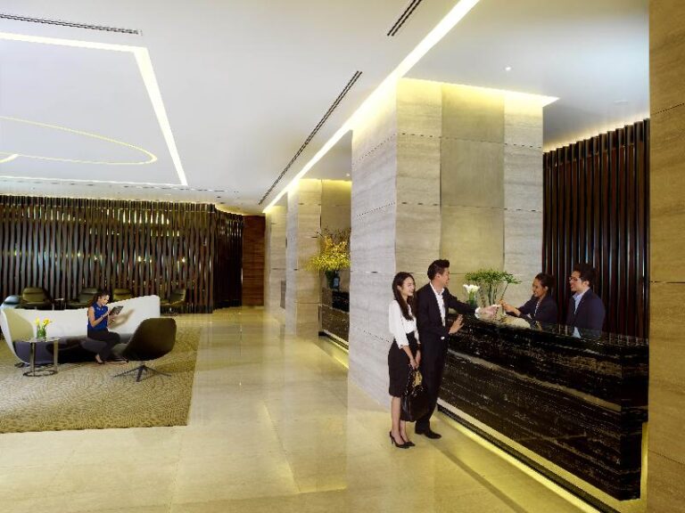 Reception desk with staff at One Farrer Hotel, Farrer Park Singapore
