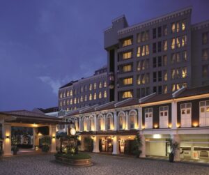 Village Hotel Albert Court lit at dusk on Albert Street, Singapore